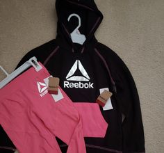 Brighten Up Her Wardrobe With This Adorable Set From Reebok. This Style Is A Hoodie And A Pair Of Joggers Made From A Soft Material. Pink Fleece Activewear Athleisure Style, Pink Winter Sportswear Activewear, Pink Hoodie For Gym Activewear, Pink Fleece Athleisure Activewear, Pink Activewear Hoodie For The Gym, Pink Fleece Sporty Activewear, Pink Hoodie For Gym, Sporty Pre-shrunk Hooded Tops, Pink Sporty Fleece Activewear