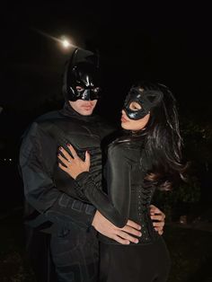 a man and woman dressed up as batman and catwoman in the dark knight costume