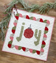 a quilted christmas ornament on a wooden surface