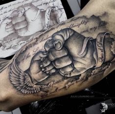 a man's arm with a fist tattoo on it, and an inscription in the middle