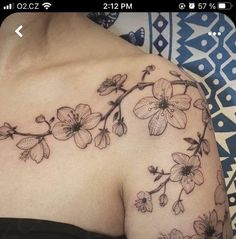 a woman's shoulder with flowers on it