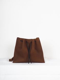 "Brown medi leather crossbody bag minimalist, Handmade leather bag, hygge leather bags, women crossbody bag, ethical bags, sustainable gifts. Cognac brown leather Origen bag Medium size. The origin collection is the simplest and purest of all my designs, the high quality of the leather and its simple lines make each bag special and unique. The medium origin leather bag is your perfect size for your everyday, traveling or going out. You can carry it over the shoulder or across the body, since the Minimalist Brown Leather Hobo Bag, Minimalist Textured Leather Shoulder Bag, Minimalist Leather Shoulder Bucket Bag, Minimalist Leather Crossbody Bucket Bag, Minimalist Soft Leather Crossbody Bucket Bag, Minimalist Brown Soft Leather Hobo Bag, Minimalist Satchel Shoulder Bag With Leather Lining, Minimalist Leather-lined Satchel Shoulder Bag, Minimalist Leather Shoulder Bag, Vegetable-tanned