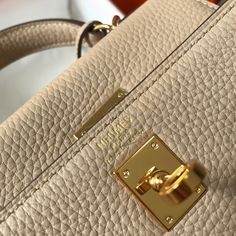 a close up view of a purse with a gold lock on it's handle