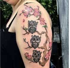 a woman with an owl tattoo on her arm