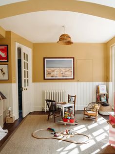 an instagram photo of a living room with toys on the floor and furniture around it