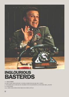 a man in uniform sitting at a table with an old phone on his desk and the caption inglourious basterds