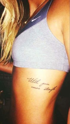 a woman with a tattoo on her stomach that says,'little town comes straight ahead '