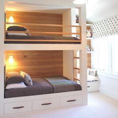 two bunk beds in a room with white walls and carpeted flooring, one is built into the wall while the other is made out of wood