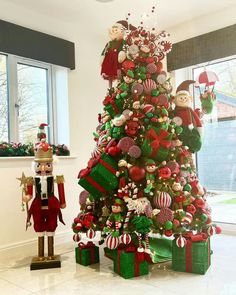 a decorated christmas tree in the corner of a room