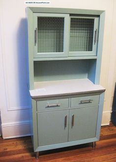 a gray cabinet with two doors and drawers