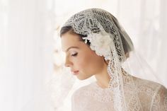 a woman wearing a veil with flowers in her hair