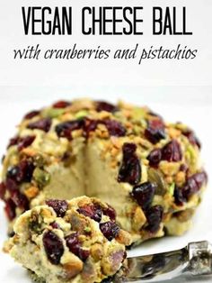 vegan cheese ball with cranberries and pistachios on a plate