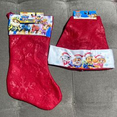 two children's christmas stockings with paw patrol designs on them sitting on a couch