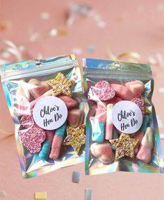 two bags filled with pink and gold candies