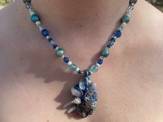 A great piece for anyone looking to get a unique product. I never replicate my work, so they're truly one-of-a-kind. This one is blue and white with a piece of quartz, a variety of seashells, and other metallic elements.  It will make a great birthday present or simply an addition to your jewelry display box  Check out our other listing for other great stuff :) Whimsical Blue Pendant Jewelry, Handmade Ocean-inspired Blue Shell Necklace, Unique Blue Necklace For Beach, Blue Shell Necklace As A Gift, Ocean-inspired Blue Shell Necklace As A Gift, Ocean-inspired Blue Shell Necklace As Gift, Ocean-inspired Blue Shell Necklace Gift, Blue Shell Bohemian Necklaces, Handmade Blue Shell Necklaces