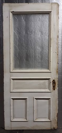 an old white door with a glass window