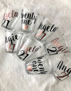 six personalized shot glasses with the names of each drink and their date on them