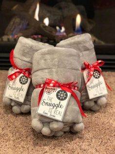 two gray stuffed animals sitting next to each other on top of a carpeted floor