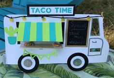 a paper cut out of a taco truck with a sign on the side that says taco time