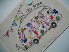 a small embroidered bus with flowers on it and a button in the middle that says live little dream