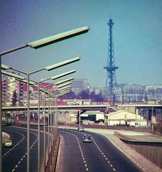 an empty highway with cars driving on it and the eiffel tower in the background