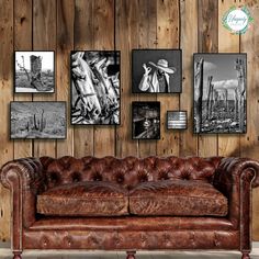 a brown leather couch sitting in front of a wooden wall with pictures on the wall