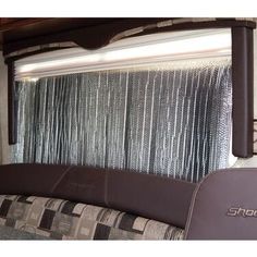 the inside of a camper with curtains on it