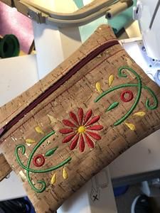 an embroidered purse sitting on top of a table