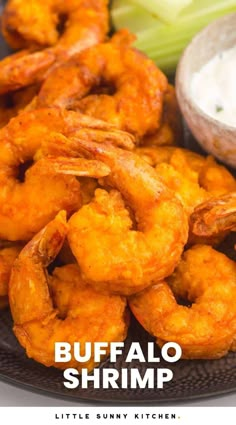 buffalo shrimp is served with ranch dip and celery on the side for dipping