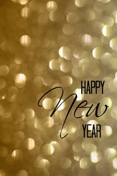 the words happy new year are written in black on a gold boket background