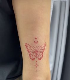 a small butterfly tattoo on the left ankle and right leg, with stars and moon