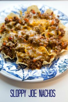 sloppy joe nachos on a blue and white plate with the title above it