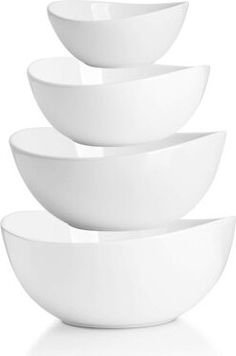 four white bowls stacked on top of each other