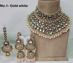 *Light Weight Gold Kundan Adjustable choker necklace set with earrings and tikka. *Studded with kundan stone. *Light Weight Gold kundan necklace. *No.1- *Necklace width- 3.8 inches (included pearl drop) *Earrings Length- 4 inches (included pearl drop) *Earrings width size- 1.5 inches *No.2- *Necklace width- 3.8 inches (included pearl drop) *Earrings Length- 4 inches (included pearl drop) *Earrings width size- 1.5 inches *No.3- *Necklace width- 3.8 inches (included pearl drop) *Earrings Length- 4 Heavy White Wedding Choker, White Choker Bridal Necklace For Reception, Heavy White Bridal Choker Necklace, Kundan Choker Sets For Wedding, Kundan Choker Jewelry Sets For Wedding, Wedding Jewelry Sets With Stone Work Choker, Heavy Wedding Choker Sets, Wedding Choker Jewelry Sets With Stone Work, Green Kundan Necklace