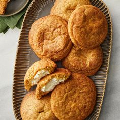 several cookies on a plate with one bite taken out