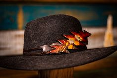 Our hand-tooled leather hat band is perfect for anyone who loves unique and eye-catching style. It features a dead-themed, 13-point lightning bolt shape in shades of brown and black. The real showstopper is the hand-carved design of the Azurescens mushroom, carefully tooled into the leather. Each hat band is one-of-a-kind due to the variations in the tooling process. Our leather hat band is not only stylish but also comfortable to wear. The soft, goatskin leather ties can be tied at any length, Custom Brown Hat Bands For Festival, Leather Hats For Fall Festival, Handmade Artisan Leather Hat, Artisan Handmade Leather Hat, Handmade Brown Hat Bands For Fall, Unique Adjustable Brown Hat Bands, Vintage Leather Hat Band For Fall, Unique Brown Hat Bands For Western-themed Events, Brown Hat Bands For Western-themed Events