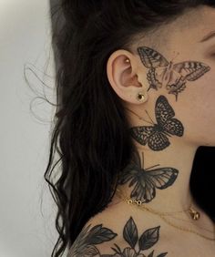 a woman with butterfly tattoos on her neck