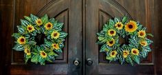 two sunflower wreaths on the front door of a house