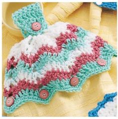 a crocheted dishcloth with buttons on it