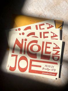 two pieces of paper with the words nice and joe on them are sitting next to each other