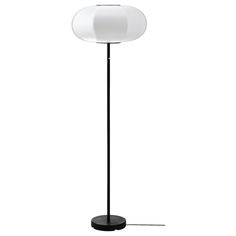 a black floor lamp with a white shade on it's base and a round light bulb