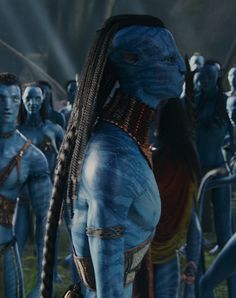 the blue man group from avatar is standing in front of other men with long braids