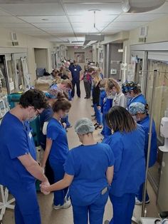 a group of medical personnel standing in a hospital hallway