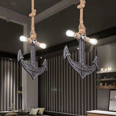 an anchor chandelier hangs from the ceiling in a room with striped walls and flooring