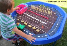 a young boy playing with a toy train set