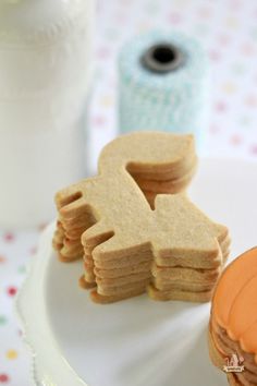 some cookies are sitting on a plate next to a roll of toilet paper and a canister