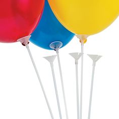 three balloons are in the air with white sticks