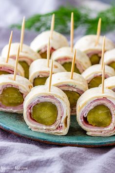 ham and cheese appetizers on a plate with toothpicks in the middle