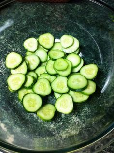 sliced cucumbers in a glass bowl on a counter top, ready to be cooked