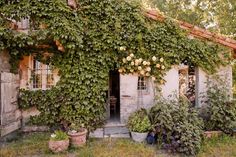 an old house covered in vines and flowers